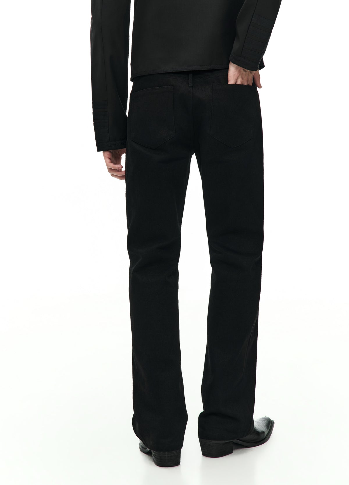 Rear view of the straight black jeans from the waist to the shoes, showing two back pockets and straight legs.