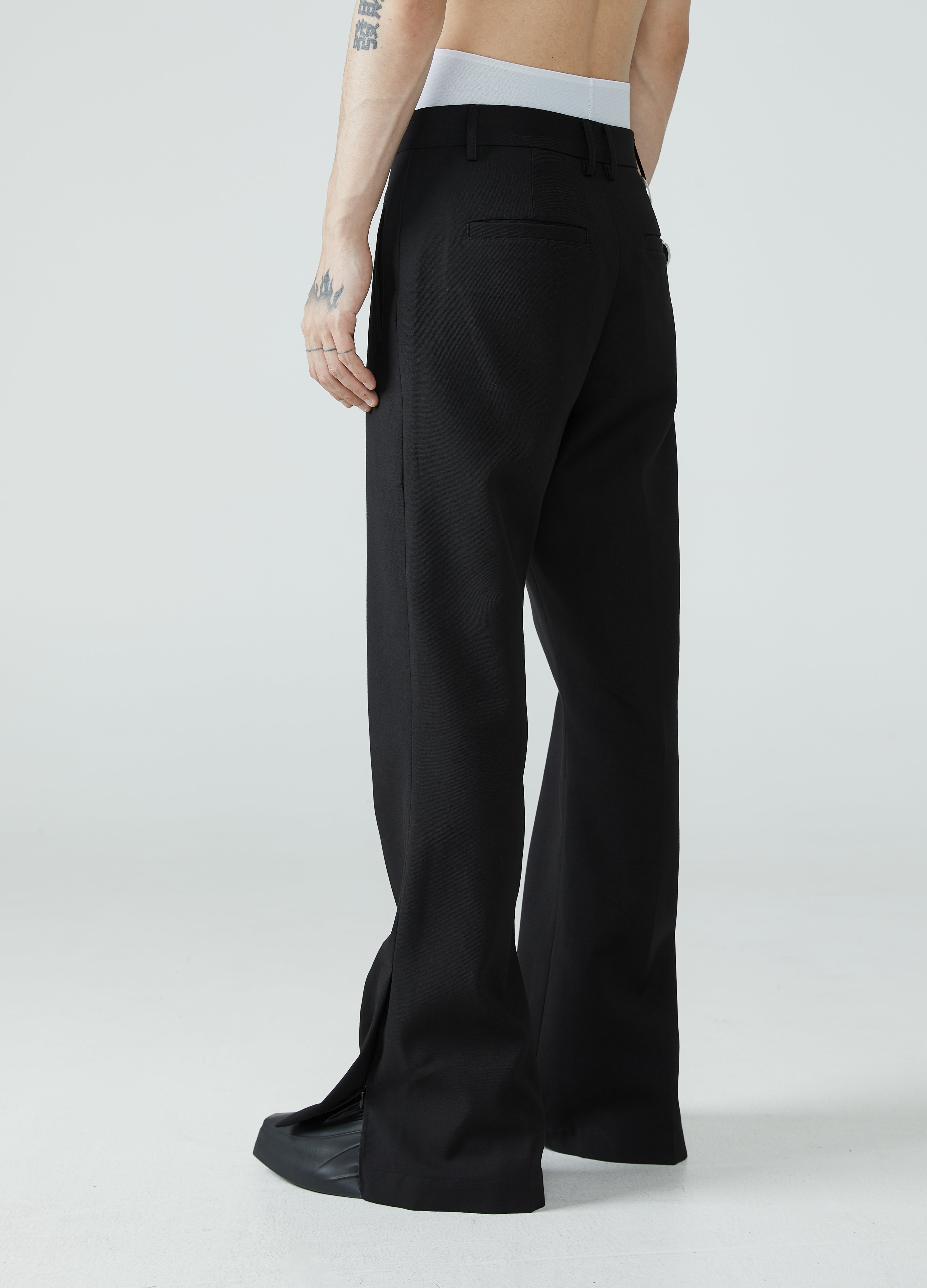 Pantaloni con spacchi e orlo a micro-stivale 23FW