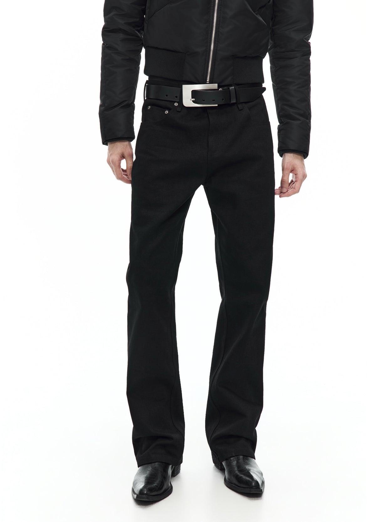 Front view of straight black jeans from the waist to the shoes, showing the belt, front pockets and long straight legs.