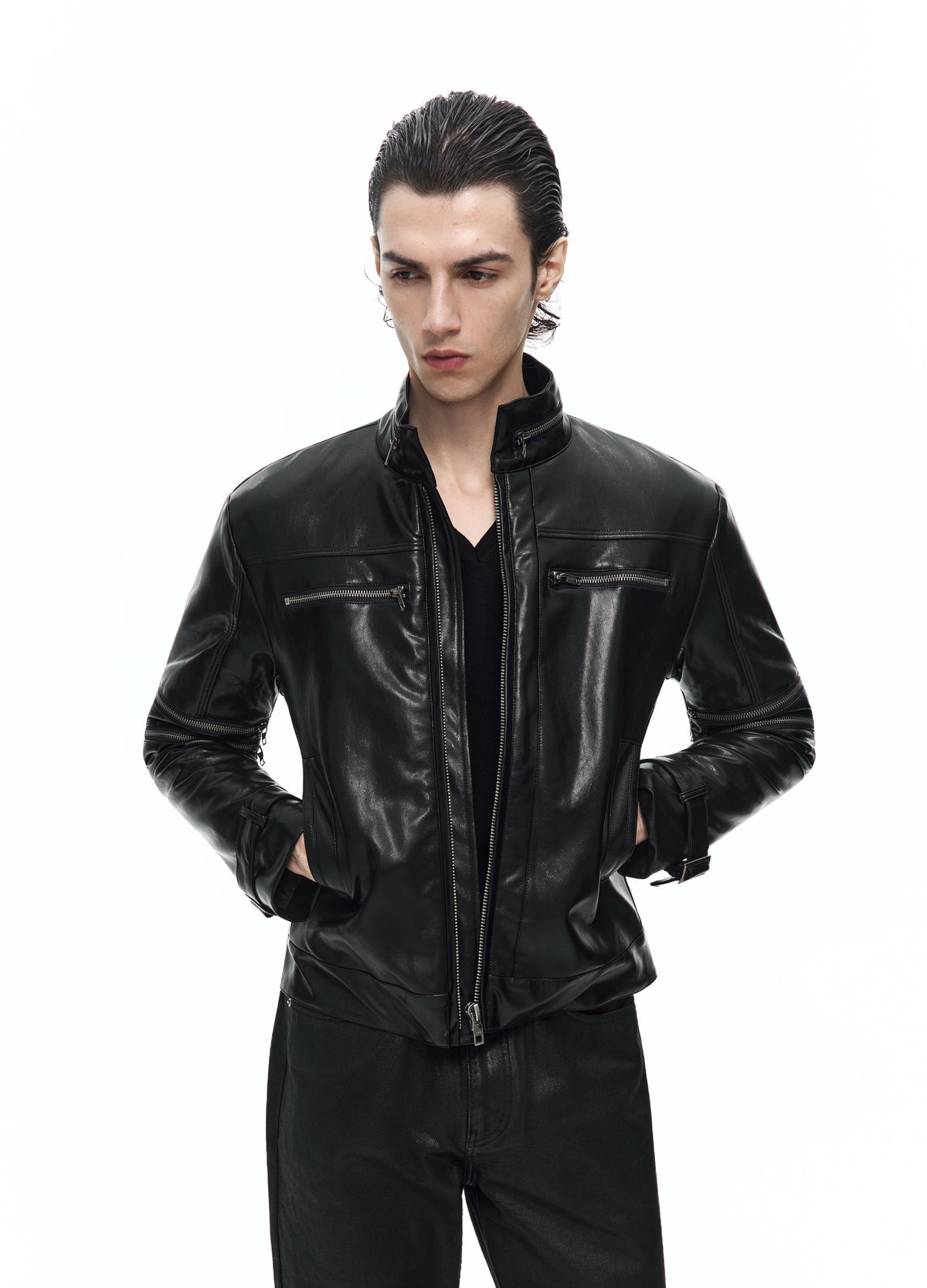 Closer front view of the open black jacket, showing the chest zips and the model with both hands in the side pockets.