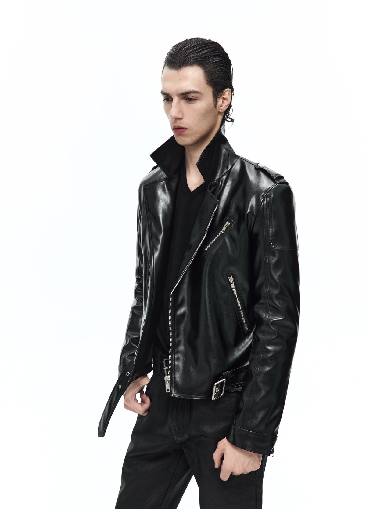 Closer three-quarter view of the open black biker jacket, showing the raised collar, diagonal zip and hanging waist-belt end.