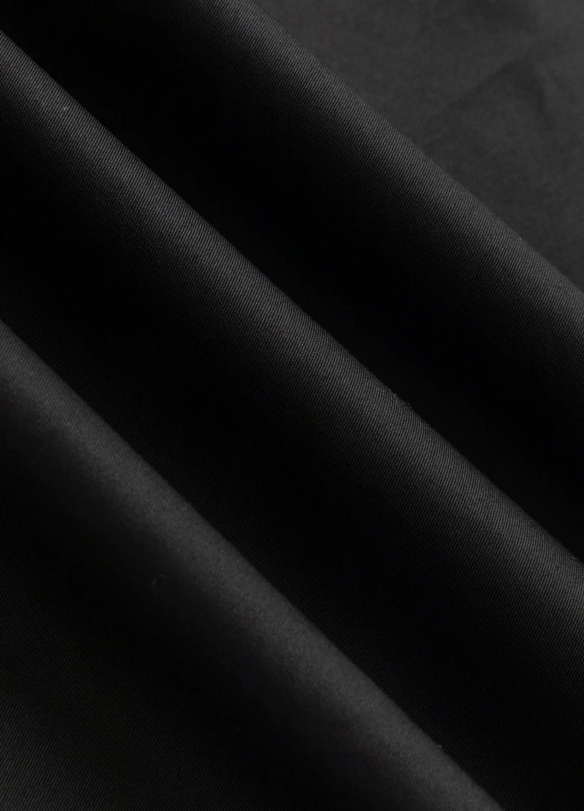 Black fabric surface.