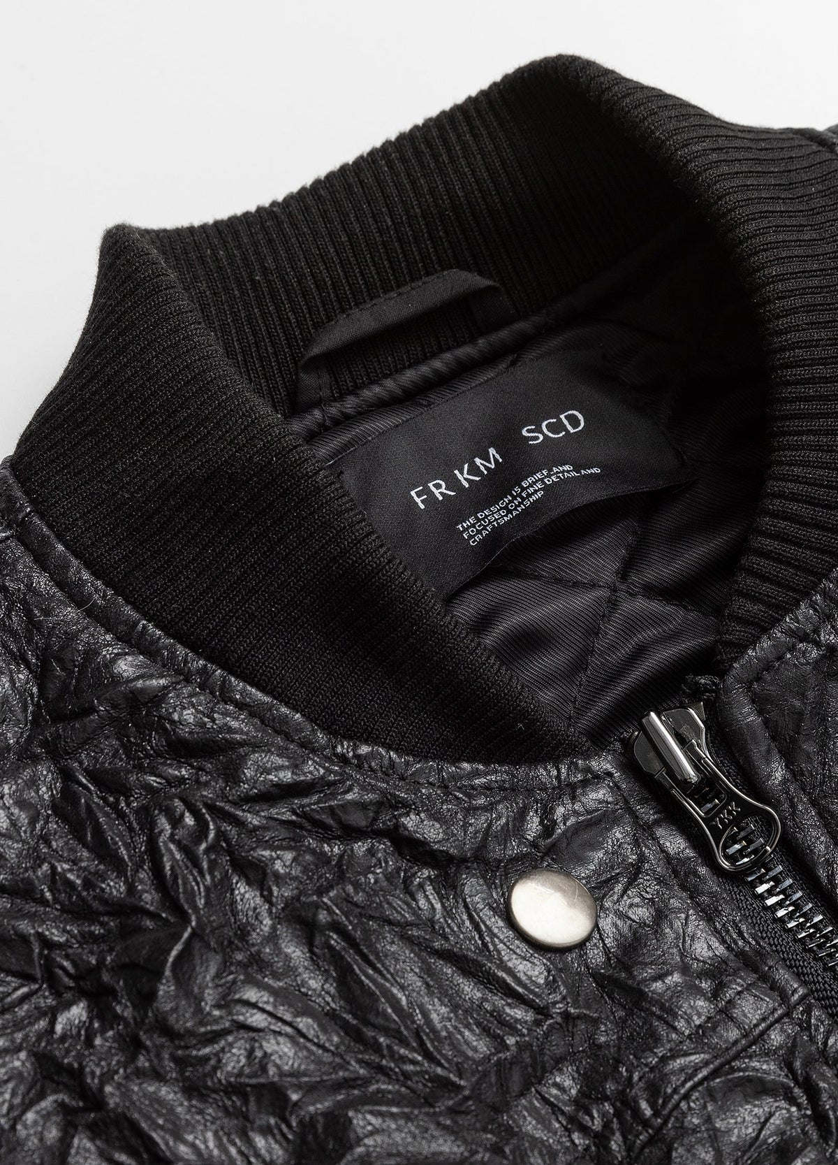 Ribbed collar with zip and snap hardware.