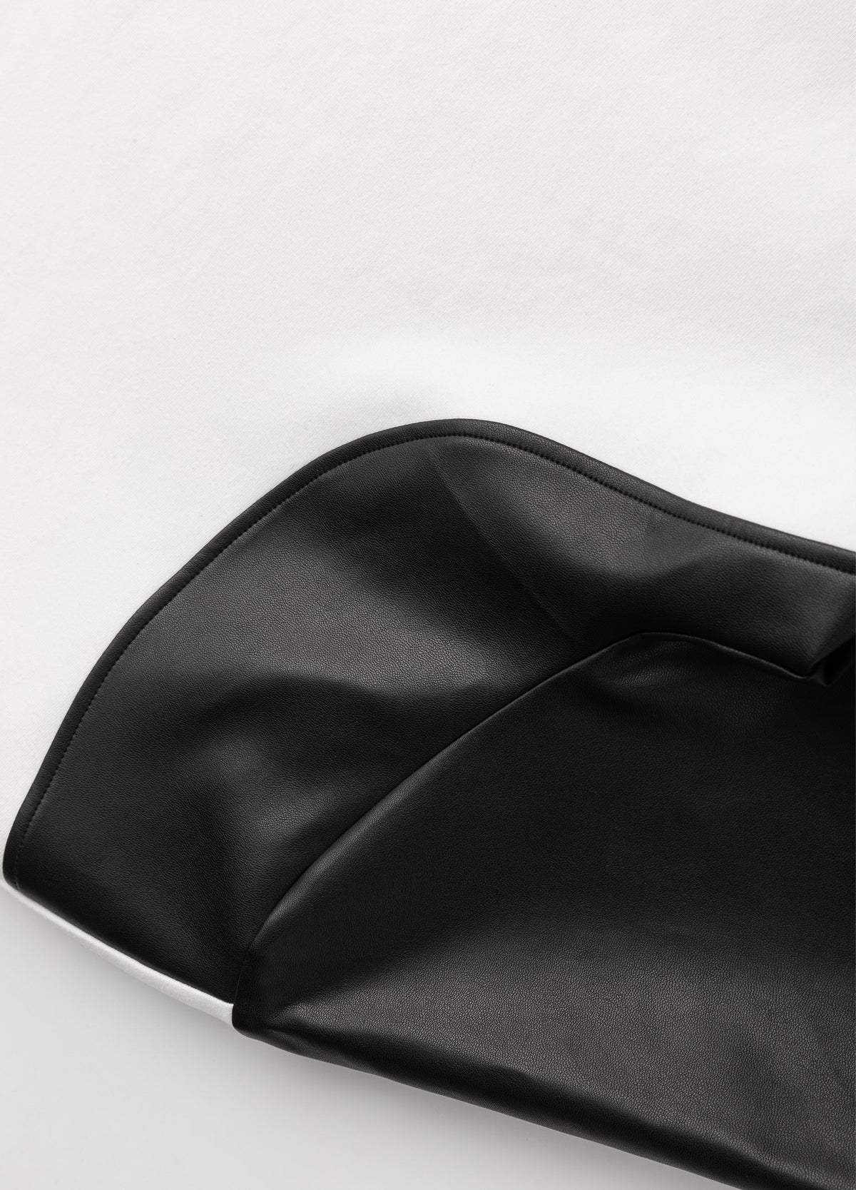 Glossy sleeve panel and curved seam.