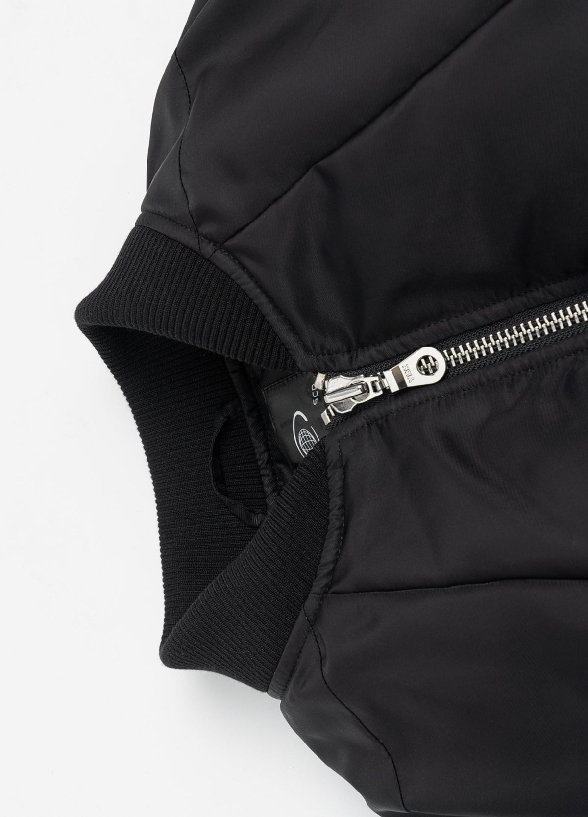 Rib-knit collar and metal zipper.