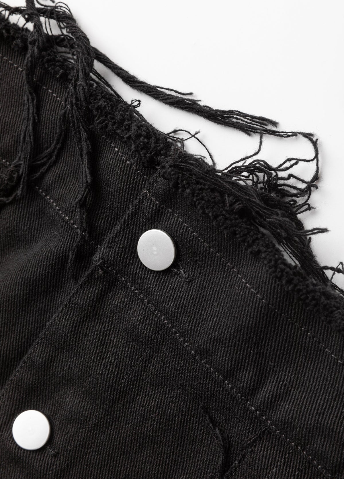 Frayed edge and metal fastenings.