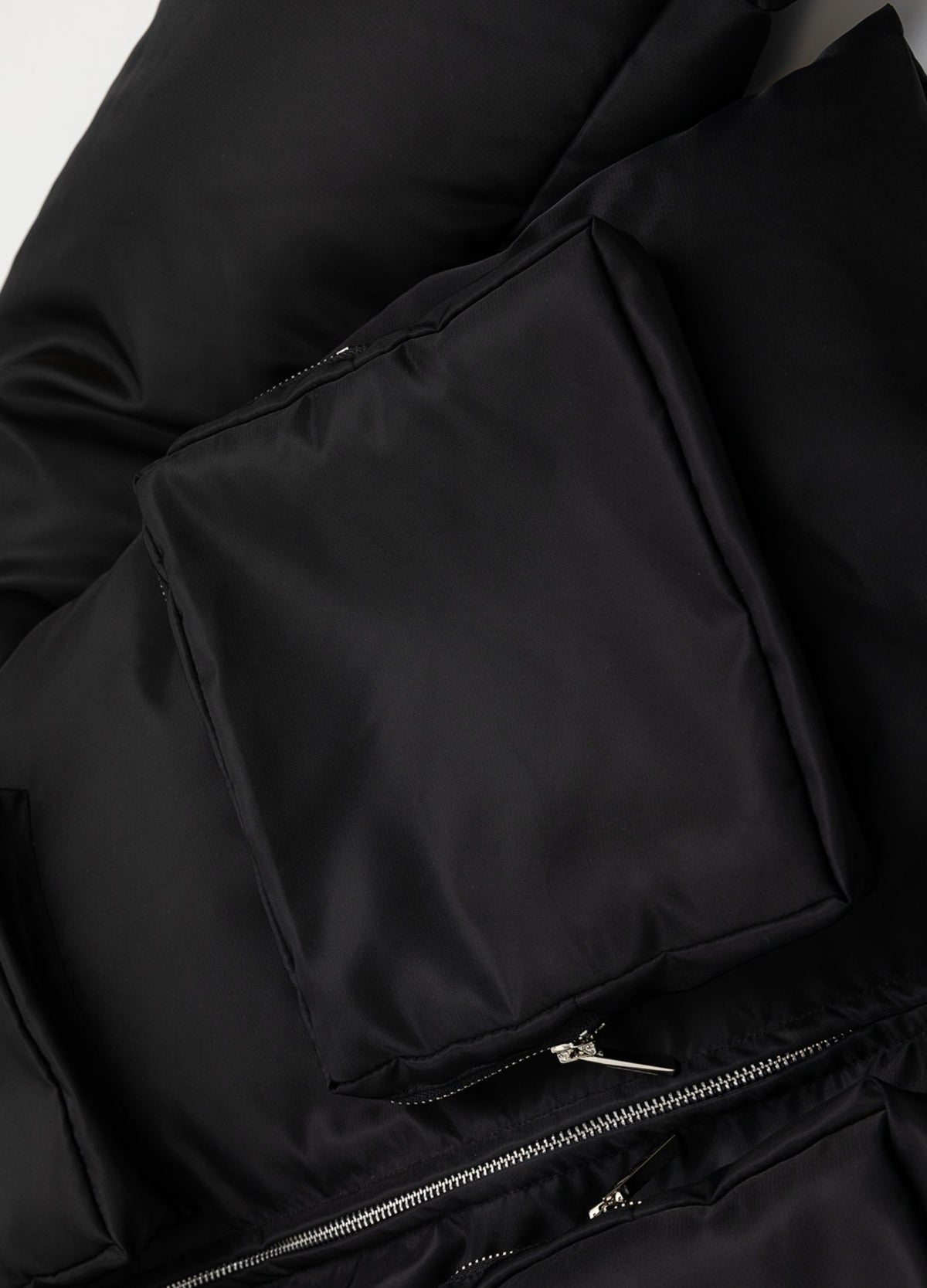 Raised front pocket and zipper.