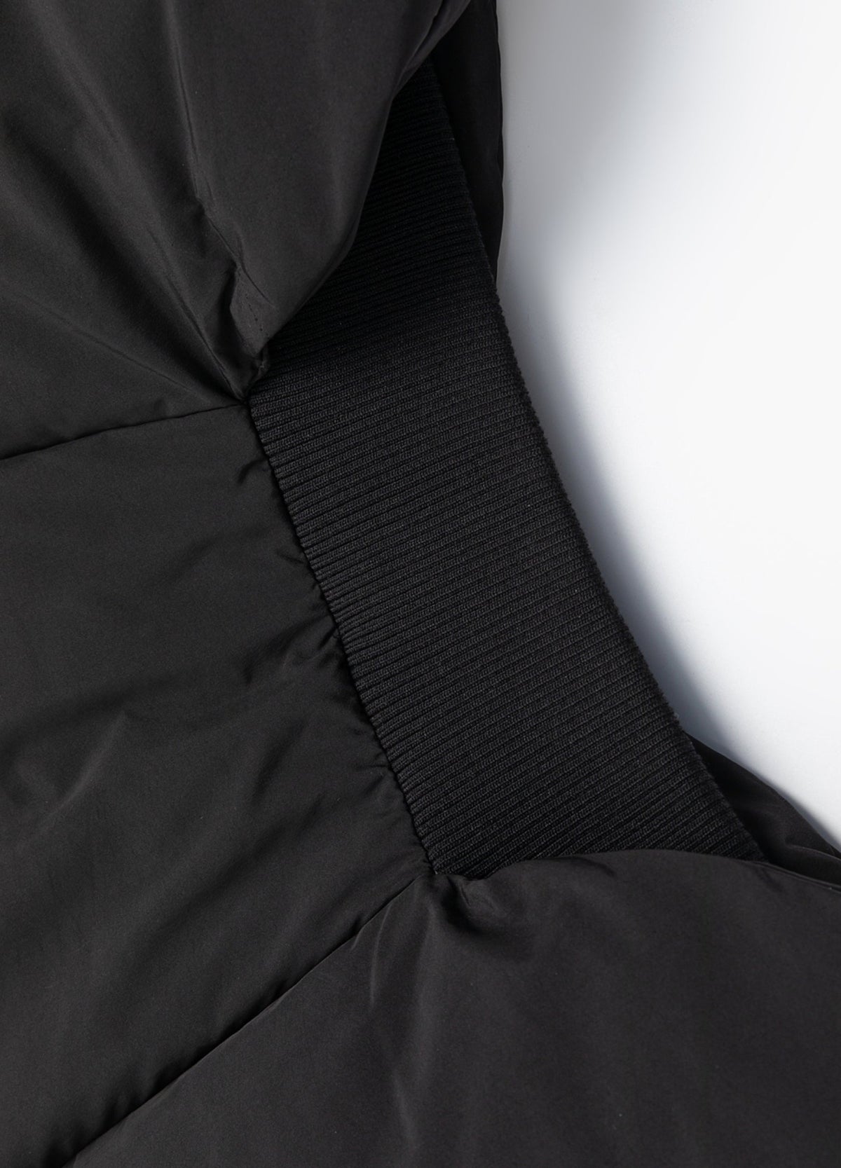 Curved rear hem with rib-knit inset.