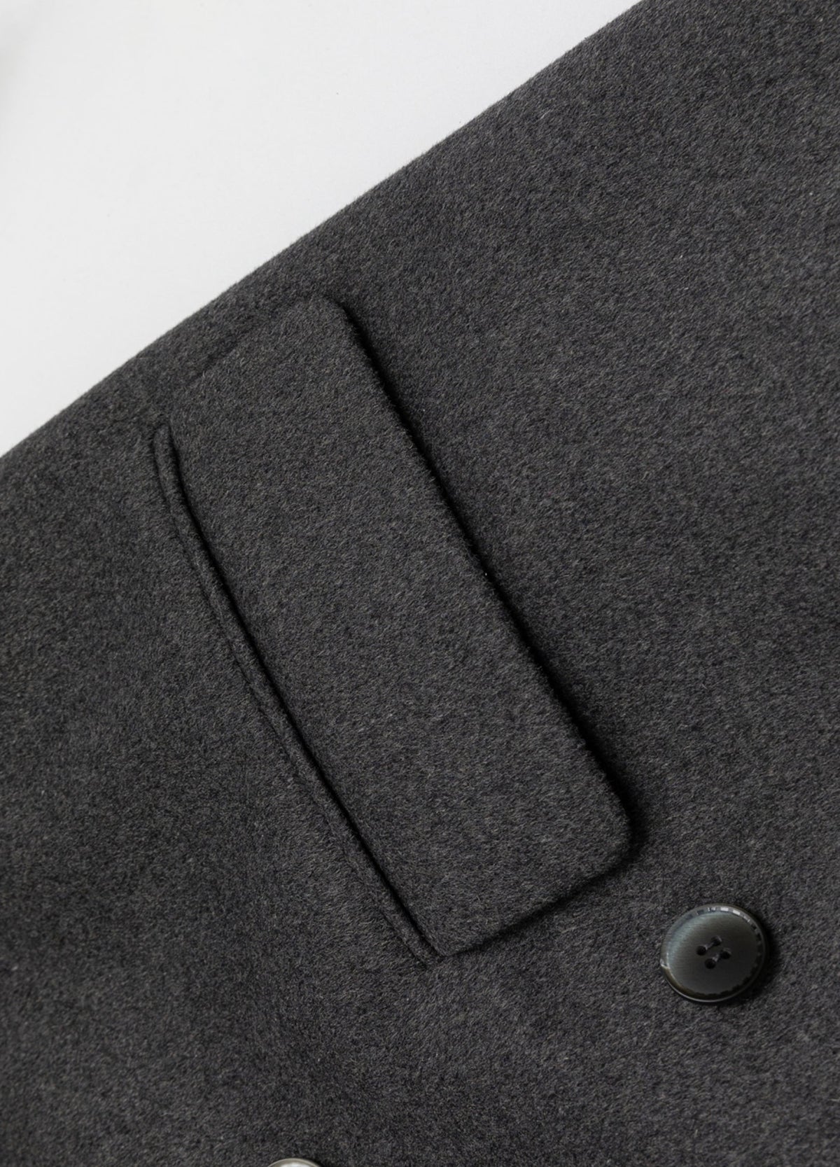 Grey flap pocket and button.
