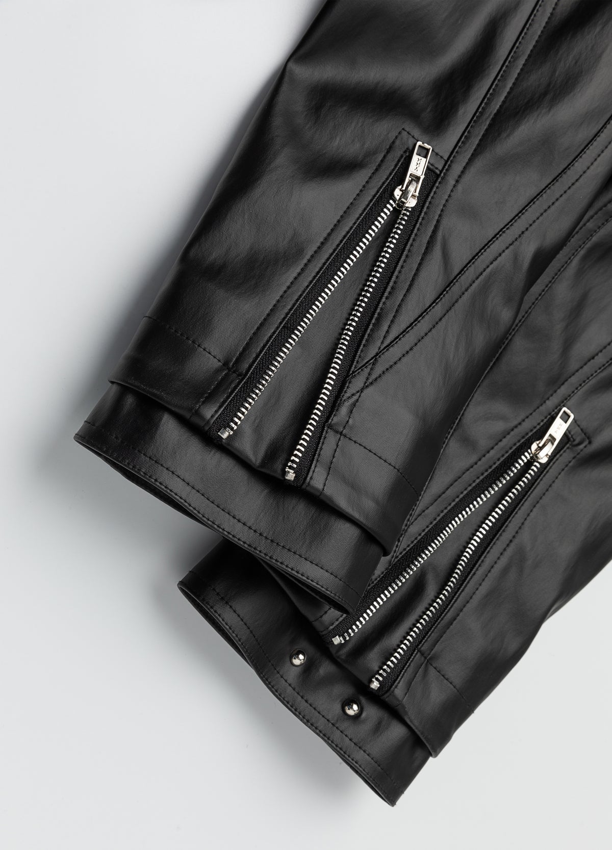 Open zip cuff beside a closed sleeve cuff.