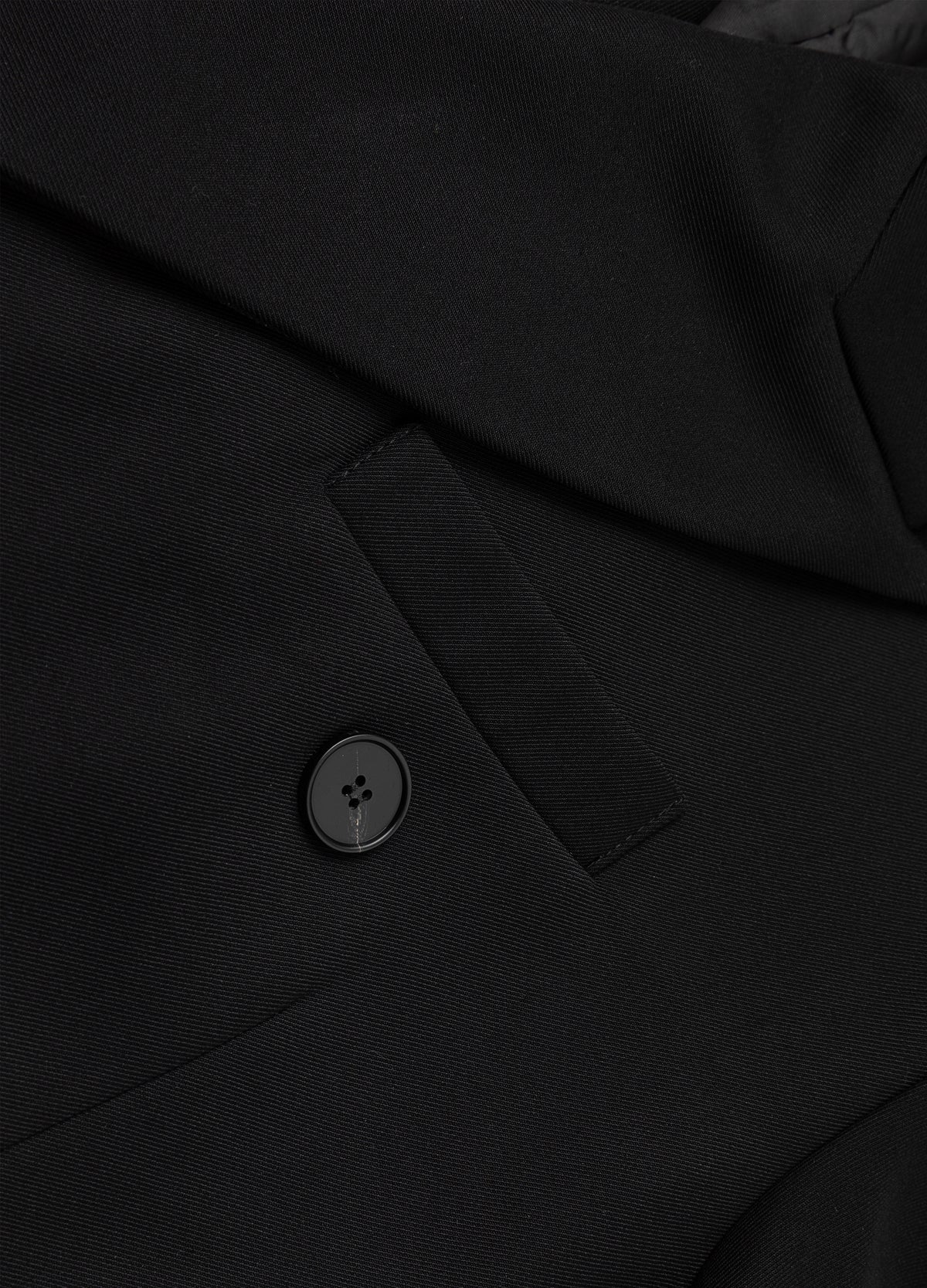 Lapel buttonhole and chest pocket detail.