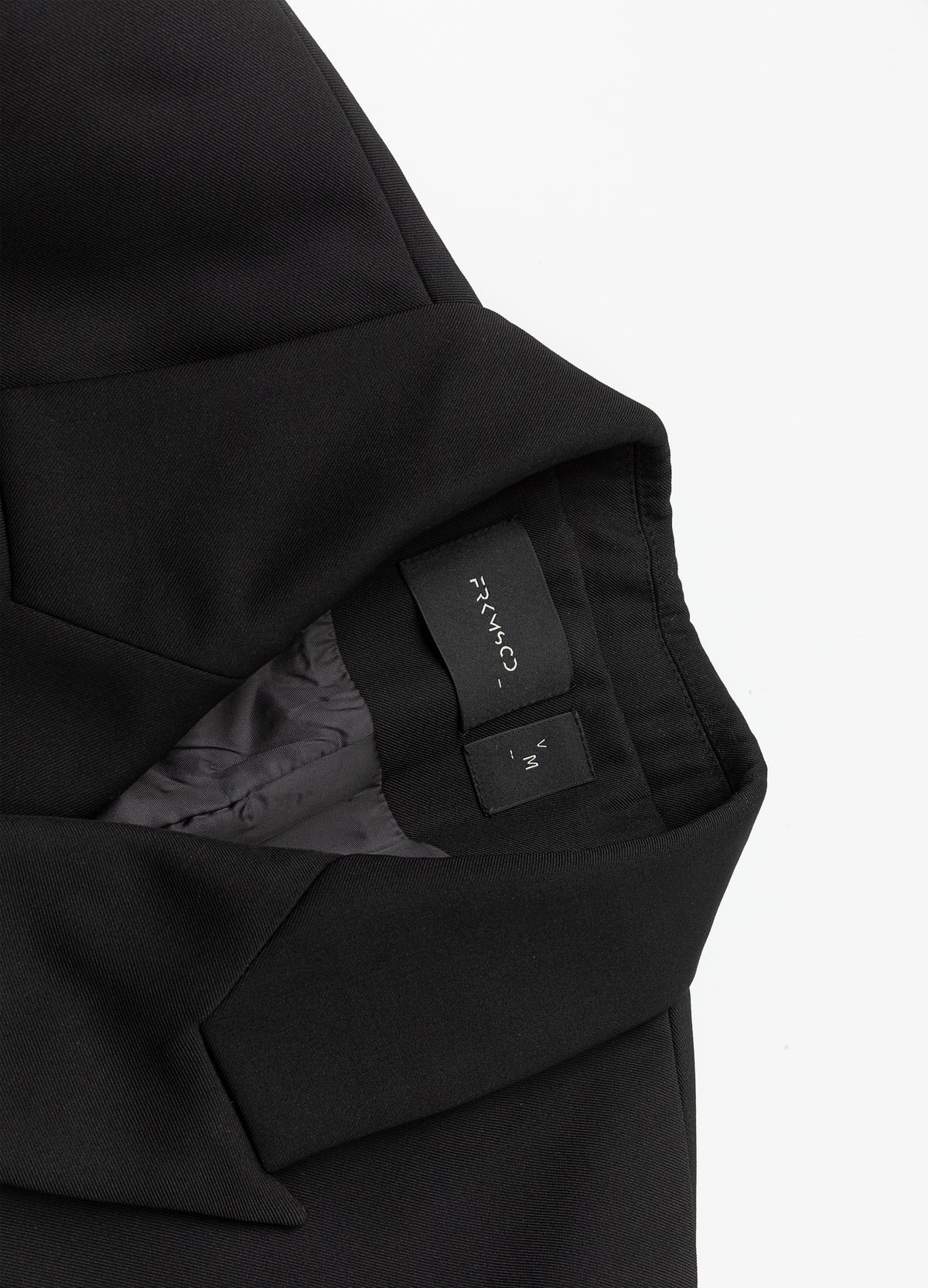 Inside neckline and collar seam.