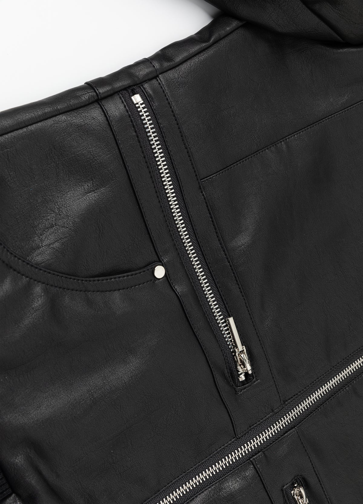 Lower zip pocket, rivet and hem detail.