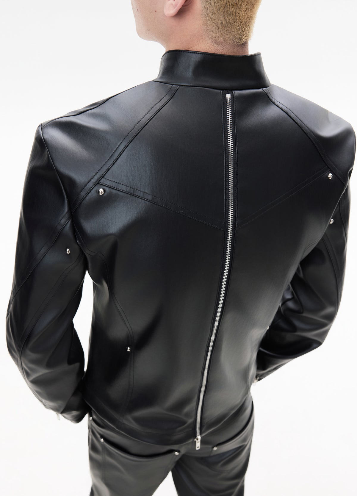 Centre-back zipper and shoulder panels.