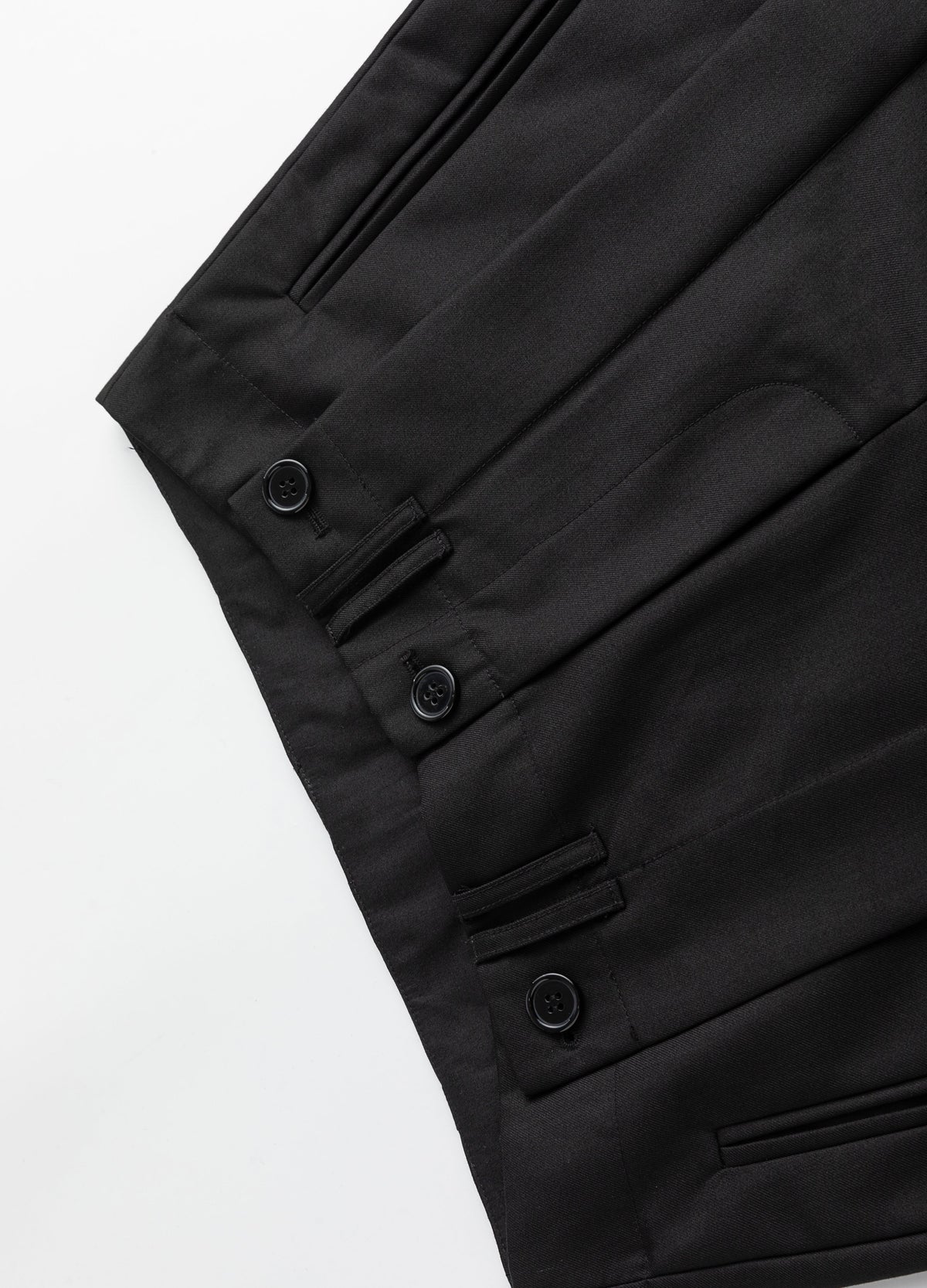 Waistband, belt loops and pleat buttons.