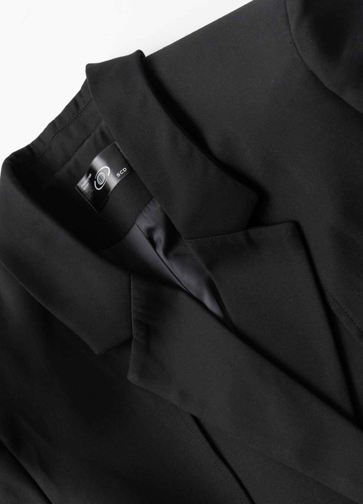 Notched lapels with layered shoulder panels.