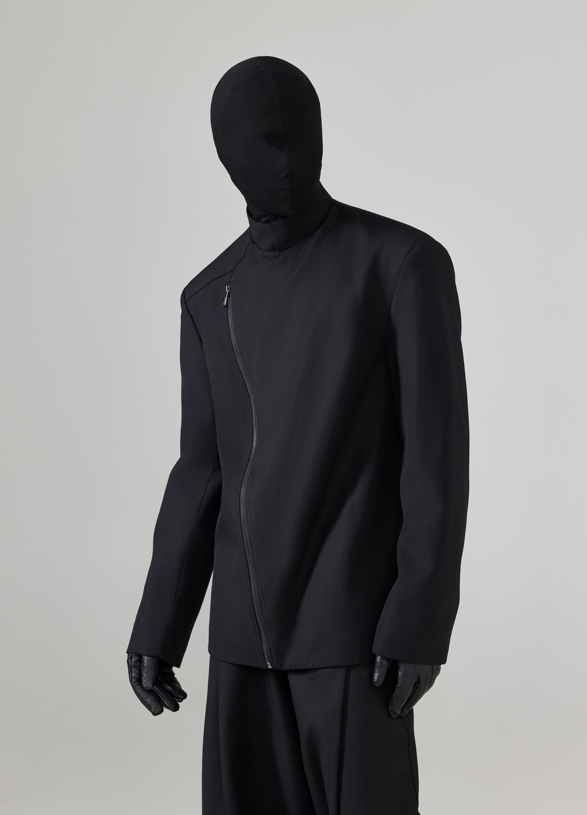 High collar with an asymmetric front opening.
