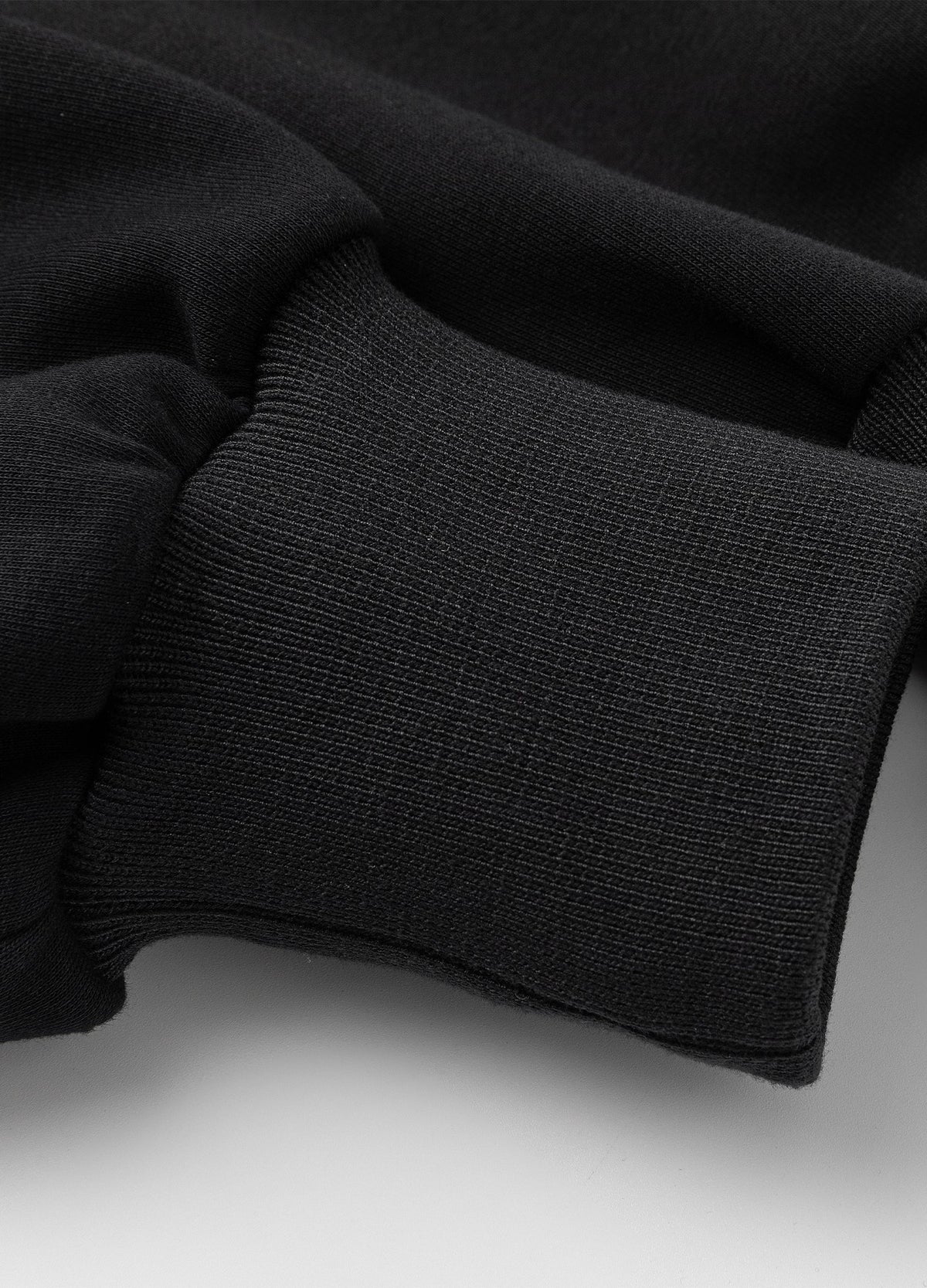 Rib-knit sleeve cuff.