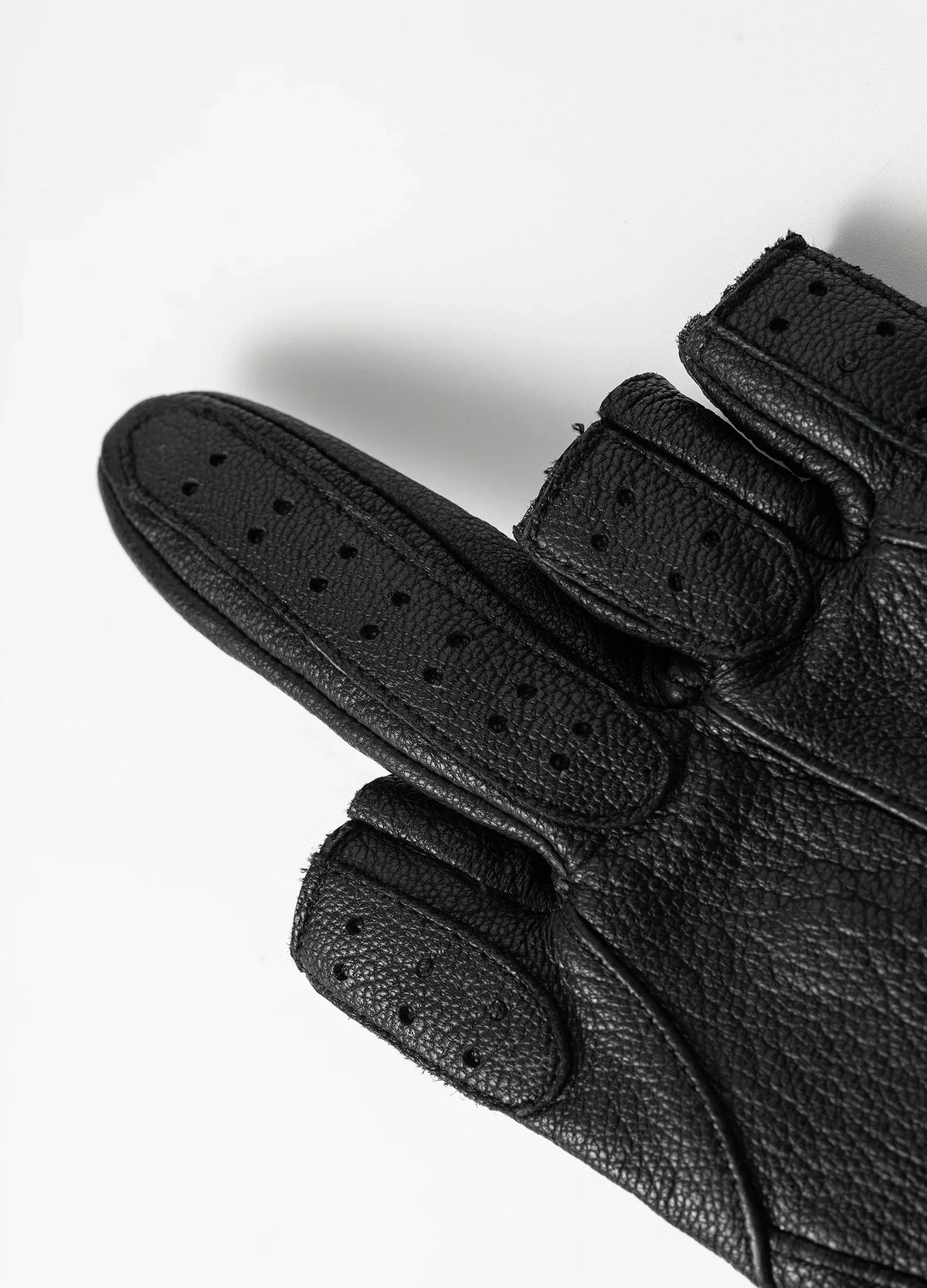 Perforated finger panels and stitched edges.