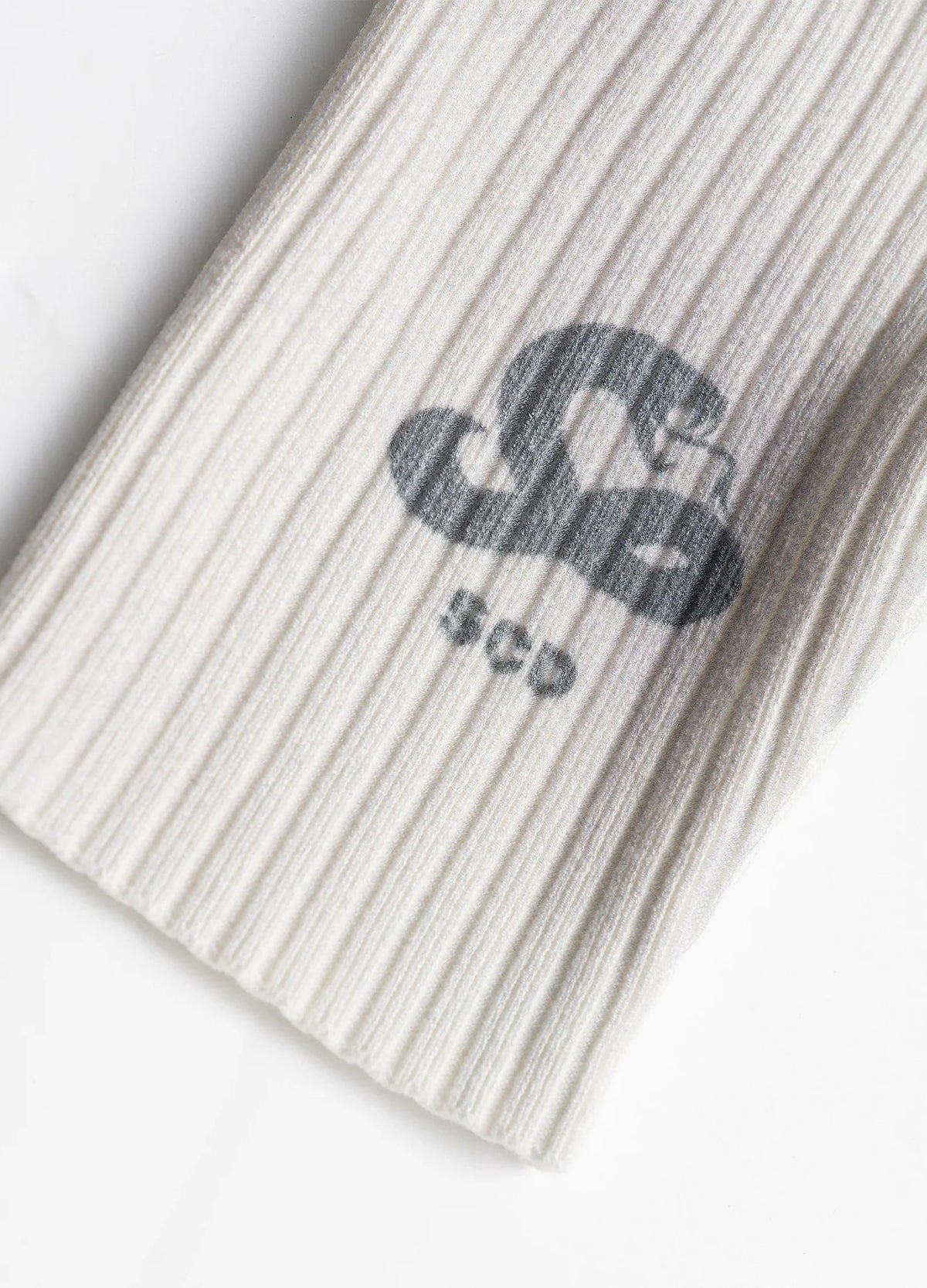 Sleeve logo on ribbed knit.