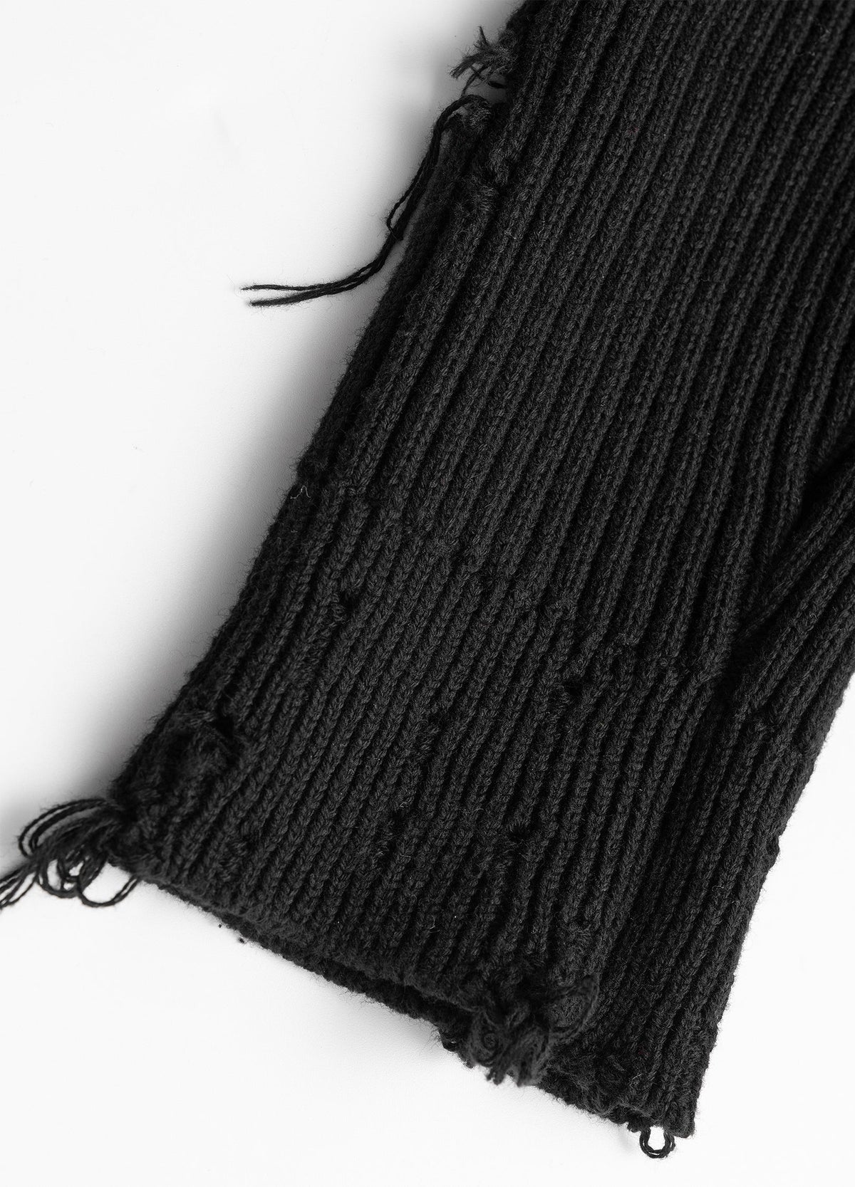 Frayed sleeve edge and open knit details.