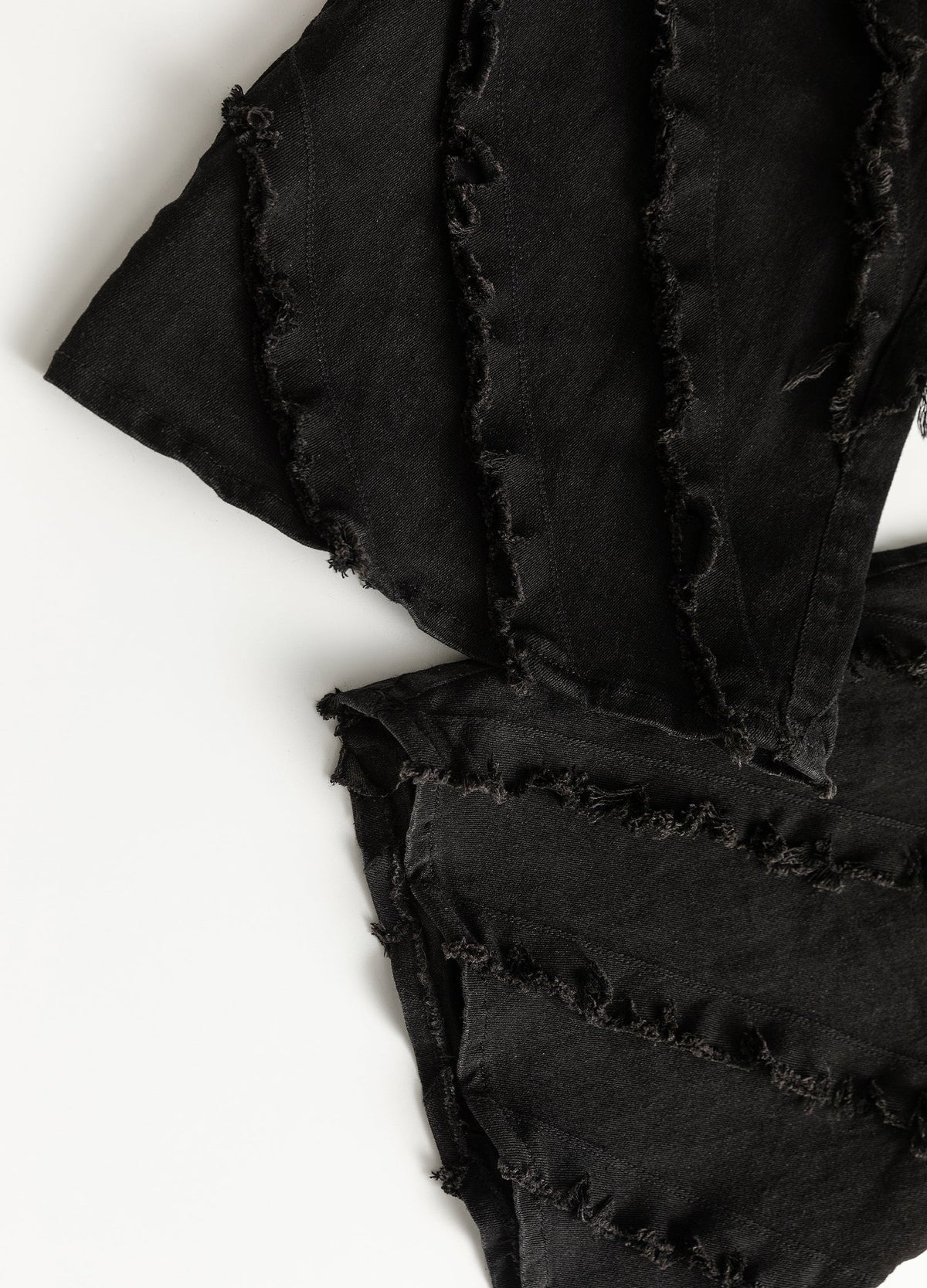 Flared hem with frayed panel edges.