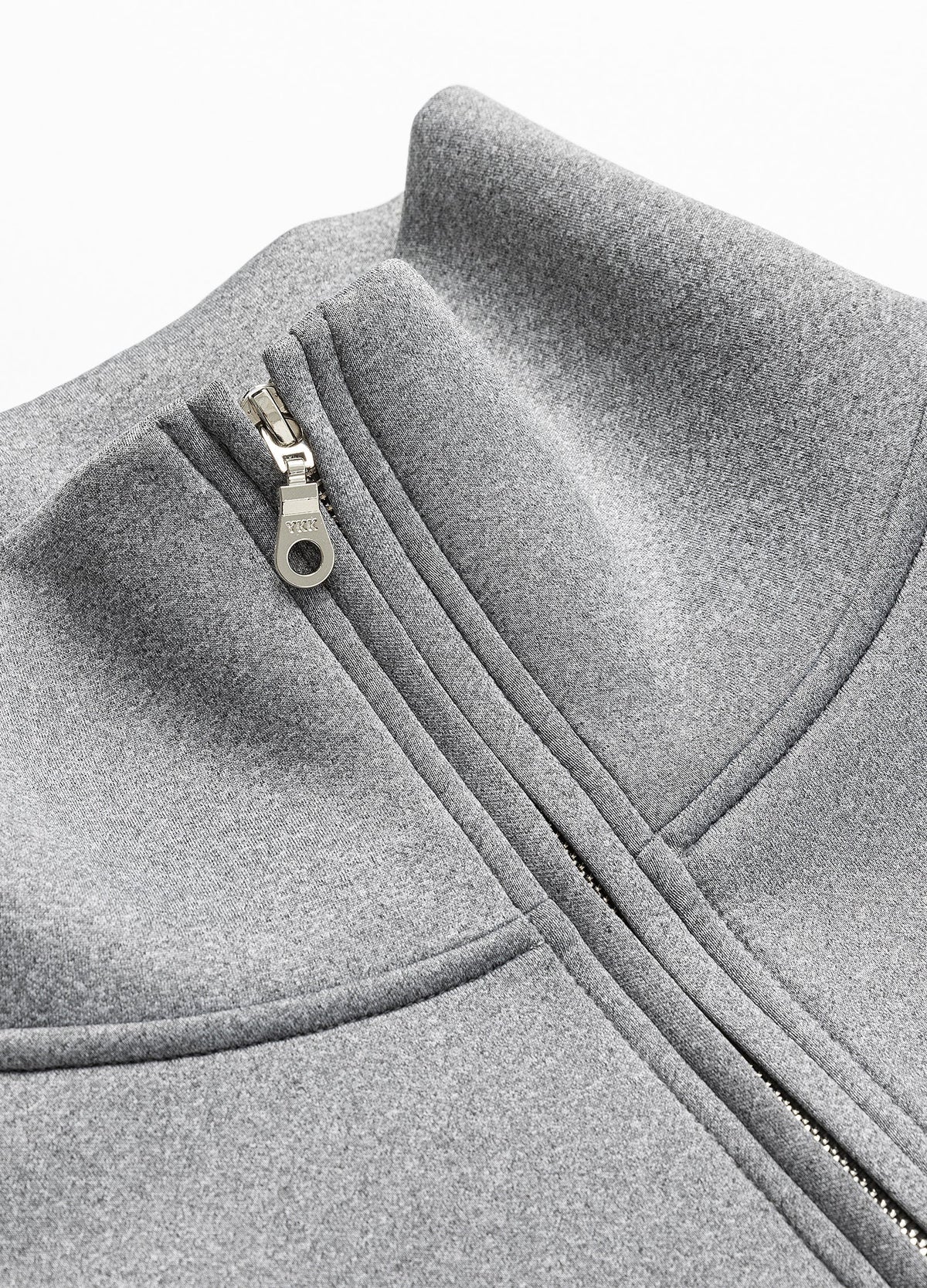 Half-zip collar and curved neckline seam.