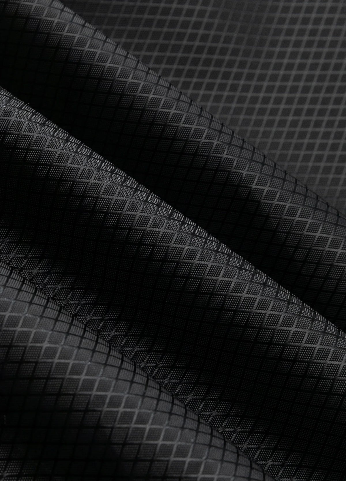 Grid-patterned fabric surface.