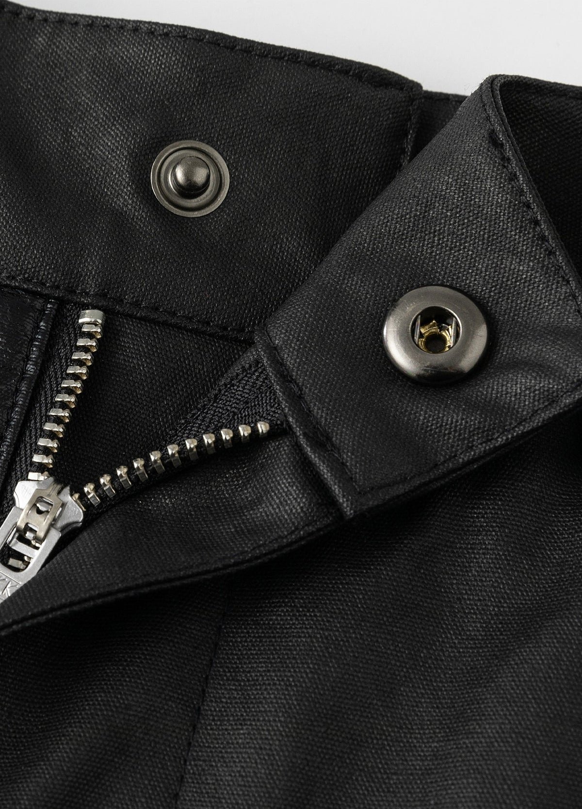 Inner snap closure and fly zipper.