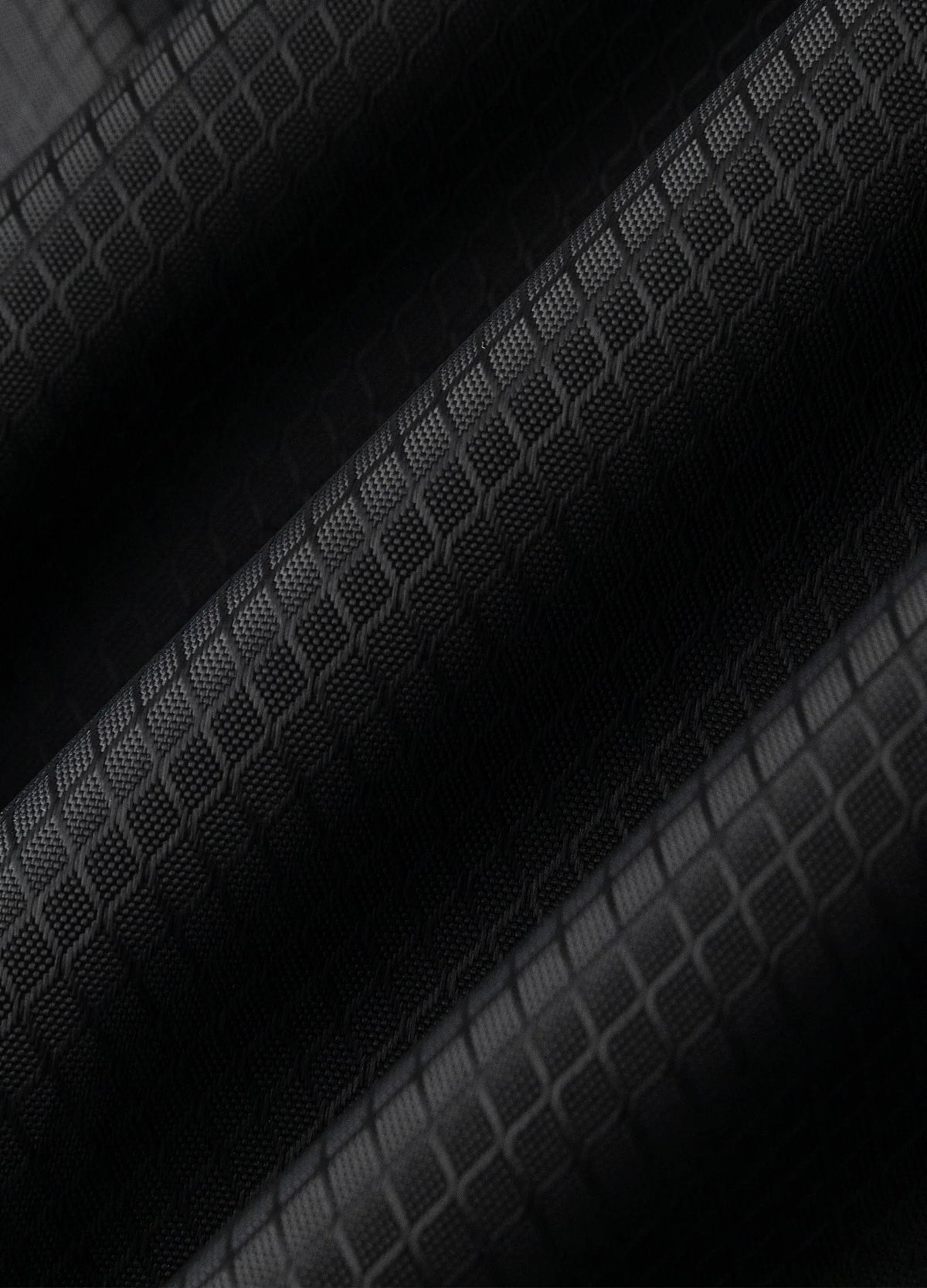 Grid-patterned fabric surface.
