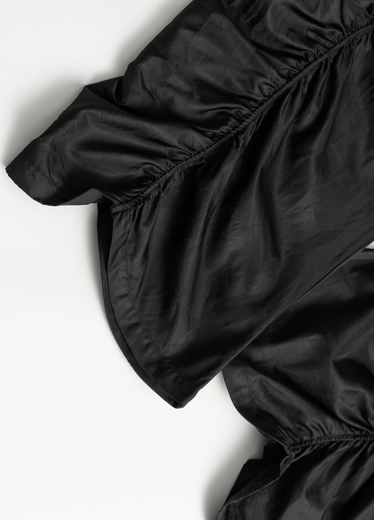 Gathered outer-leg seam and hem.